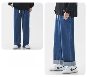 Détail de jean large bleu foncé avec taille à cordon blanc et ourlets retroussés