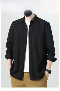Close-up of black cotton long sleeve shirt with front pocket and classic button collar