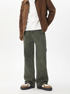 Detailed view of cargo pockets on American style dark grey-green cotton work pants