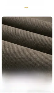 Close-up of high-quality wrinkle-resistant dark brown twill fabric with smooth texture
