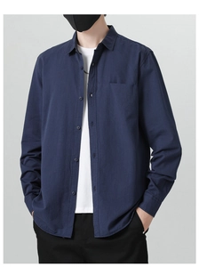 Detail of navy blue cotton long sleeve shirt for men with classic collar and front pocket