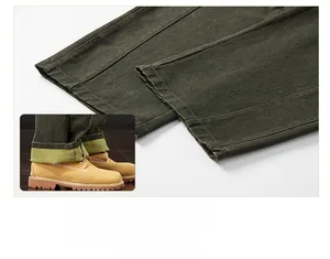 Detail of olive green heavy twill trousers hem showing fabric texture and rolled cuff style