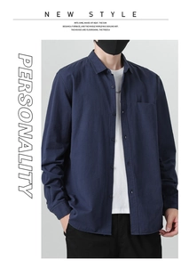 Detail of navy blue cotton shirt showing classic collar, front buttons and chest pocket