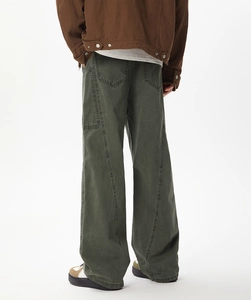 Rear view of washed dark green cargo pants featuring large pockets and loose fit