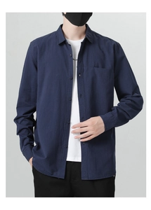 Detail of navy blue cotton shirt with chest pocket and white inner t-shirt styling
