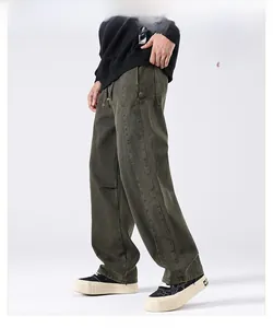 Detail view of avocado green wide-leg cargo pants with washed denim fabric and stacked cuffs