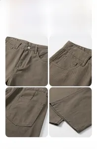 Detailed close-up of brown cargo pants showing metal buttons and stitched utility pockets