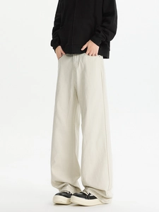 Street style view of men's cream white straight-leg trousers with relaxed fit and drape