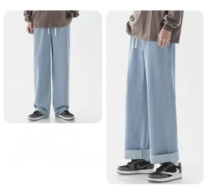 Détail d'un jean large bleu clair avec taille à cordon et ourlets retroussés