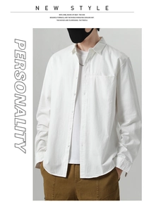 Detail of white cotton casual shirt featuring a chest pocket and natural fabric texture