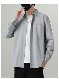 Detail of grey men's cotton leisure shirt featuring classic collar and single chest pocket