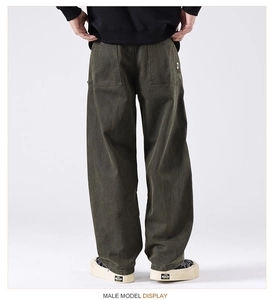 Detail view of the back pockets on olive green heavy cotton cargo pants for men