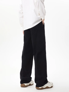 Rear view of black cargo pants with large side pockets and contrast stitching detail