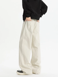 Detail of off-white wide-leg straight trousers showing loose fit and fabric texture