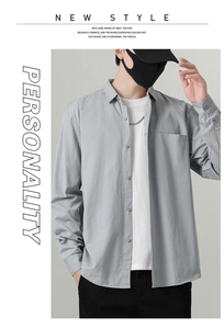 Detail view of men's casual light grey cotton shirt with chest pocket and lapel collar