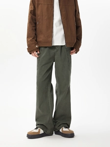 Detailed view of deep olive green cargo pants featuring white contrast stitching and pockets
