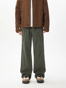Detailed view of dark green cargo pants featuring heavy canvas fabric and large side pockets