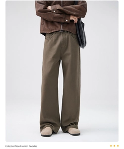 Full shot of men's loose wide-leg retro olive brown cotton trousers in street style