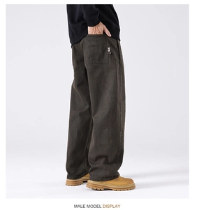 Detail view of heavy canvas workwear pants featuring a white woven label on the back pocket