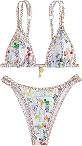 Detailed view of bikini top with Mediterranean print and central metal decorative charm