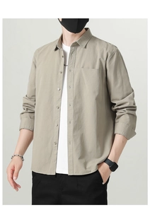 Detail shot of men's khaki cotton shirt with chest pocket and button-down collar design