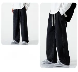 Détail d'un pantalon en jean noir large doté d'un cordon de serrage blanc à la taille