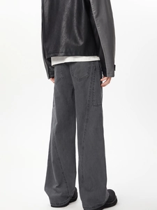 Detail view of washed dark grey wide-leg cargo pants with pockets and distressed finish