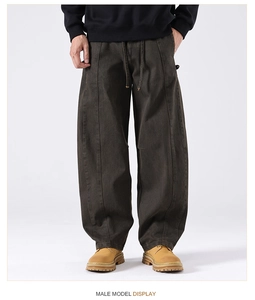 Detail of heavy cotton cargo pants featuring elastic drawstring waist and vintage brown fabric