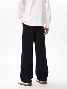 Detail view of the back pockets and heavy twill cotton fabric on black cargo pants