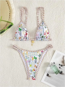 Detailed flat lay of vibrant bikini set with citrus print and gold hardware accent