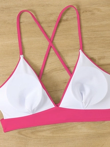 Pink and white sporty bikini top with criss-cross back straps and removable padding