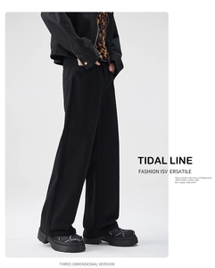Side view of men's wide-leg black denim pants featuring heavy cotton twill and loose fit