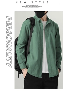 Detail of vintage green cotton shirt featuring classic lapel and single chest pocket for men
