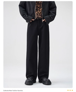 Detailed view of high-waist loose black trousers with retro street style drape