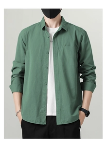 Close-up detail of the matte cotton fabric texture on a casual grey-green men's shirt