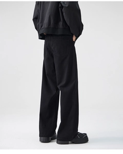 Back view of men's wide-leg black trousers showing high-density cotton texture and fit