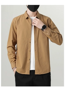 Detail of khaki cotton shirt fabric texture with classic collar and button-down front