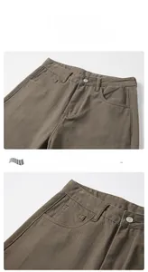 Detail view of high-waist dark brown twill pants with precise stitching and waistband