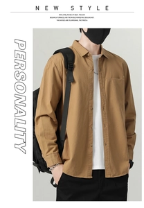 Detail of khaki cotton shirt jacket with chest pocket and white t-shirt layer