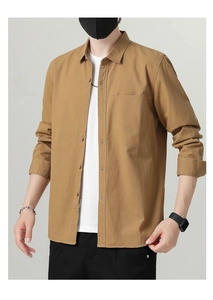Detail of khaki men's long sleeve shirt with classic collar and front pocket