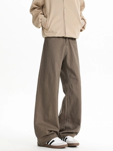 Detail view of brown wide-leg flare pants in cotton twill fabric with a minimalist cleanfit style