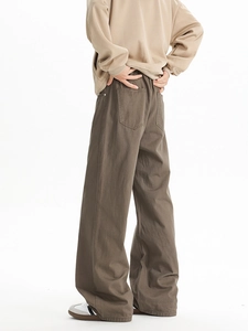 Rear view of brown wide-leg trousers showing back pockets and straight-cut silhouette