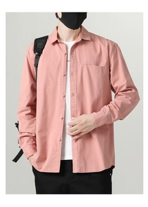 Detail of light pink men's casual long sleeve shirt showing button-up collar and chest pocket