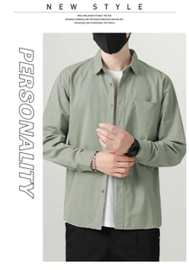 Detail of light green cotton shirt styled with a white T-shirt and casual black pants