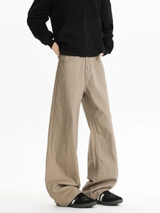 Detail of khaki wide-leg trousers showing heavy twill fabric and streetwear aesthetic