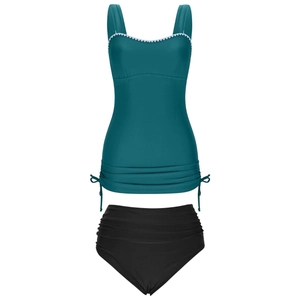 Detail of teal tankini top with white scalloped trim and adjustable side drawstrings