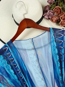 Blue mesh beach cover-up with wavy geometric patterns and lightweight sheer fabric