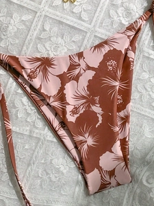 Detail of floral bikini bottoms with tropical hibiscus print and side tie strings