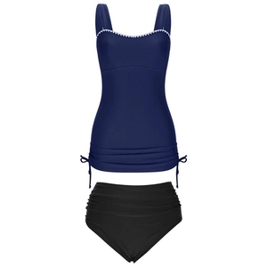 Detail of dark blue tankini top with white scalloped trim and side drawstring ties