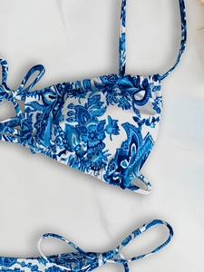 Close-up of blue and white paisley floral bikini with delicate drawstring pleats